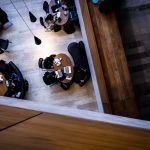 Overhead shot of students in a library cafe.