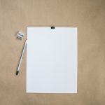 a blank piece of paper over a brown background